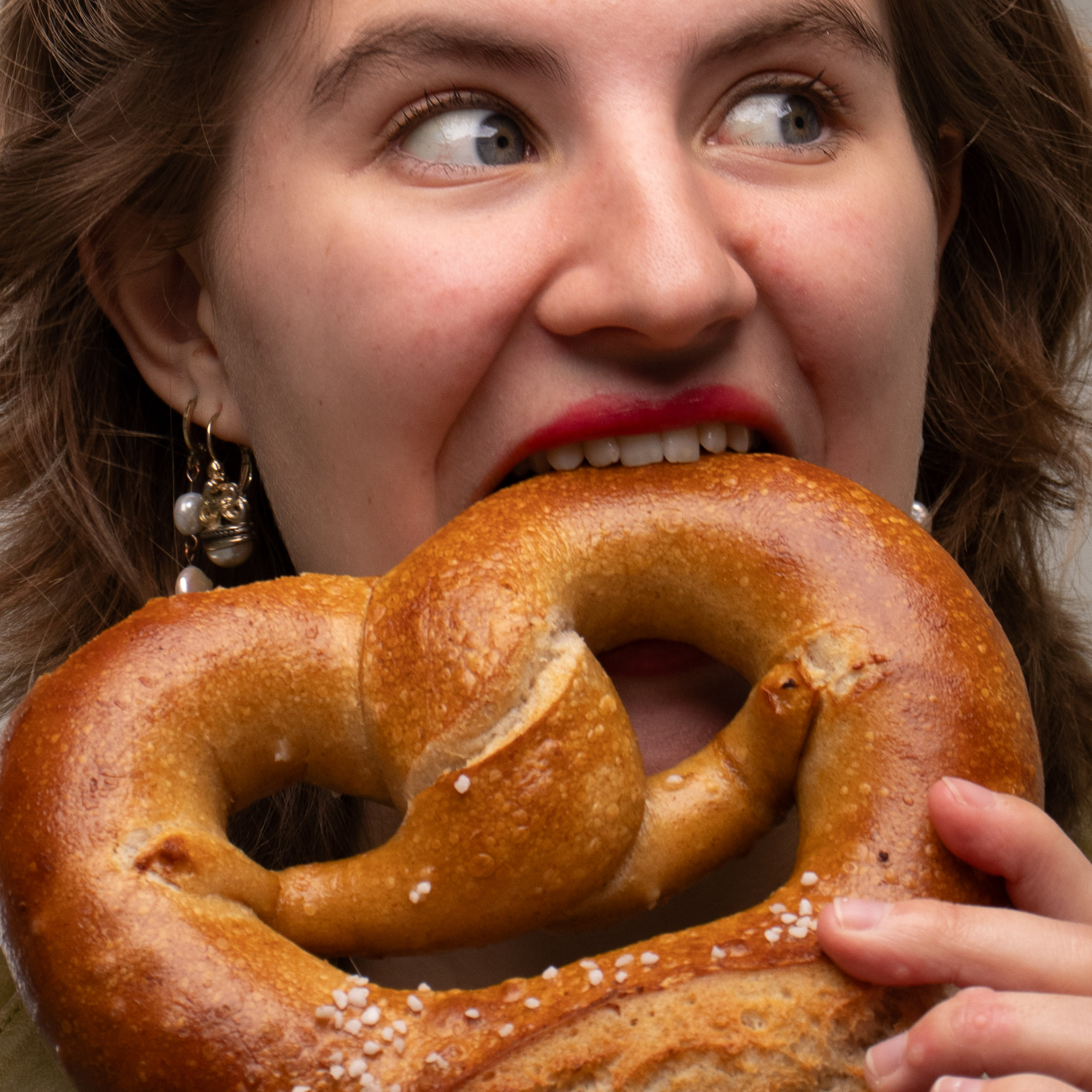 Girl eating a lrage bretzel
